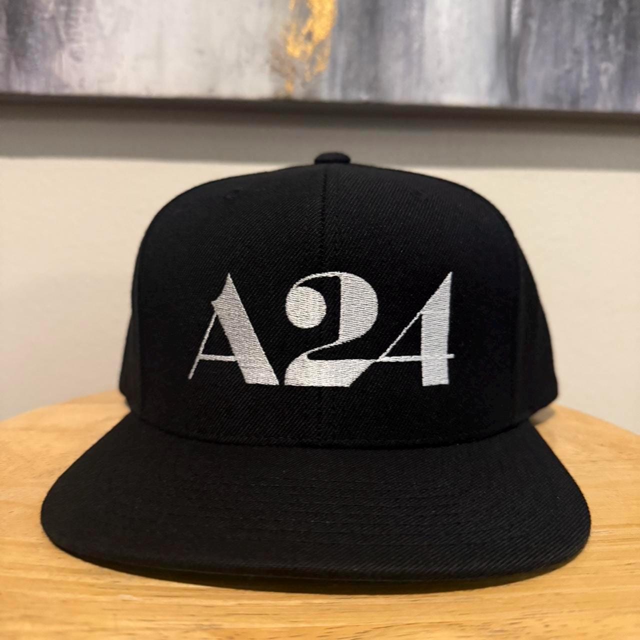 A24 black SnapBack hat